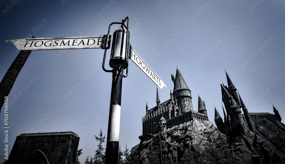 Fototapeta premium Hogsmead and Hogwarts Sign pointing to the Castle at the Wizarding World of Harry Potter area in Universal Studios Hollywood - Los Angeles, California