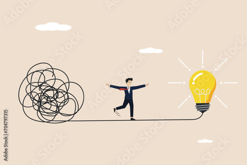 Simplify idea to find solution, creativity to solve problem, discover easy way to understand concept, smart businessman walking away from mess chaos line to simple lightbulb idea. photo