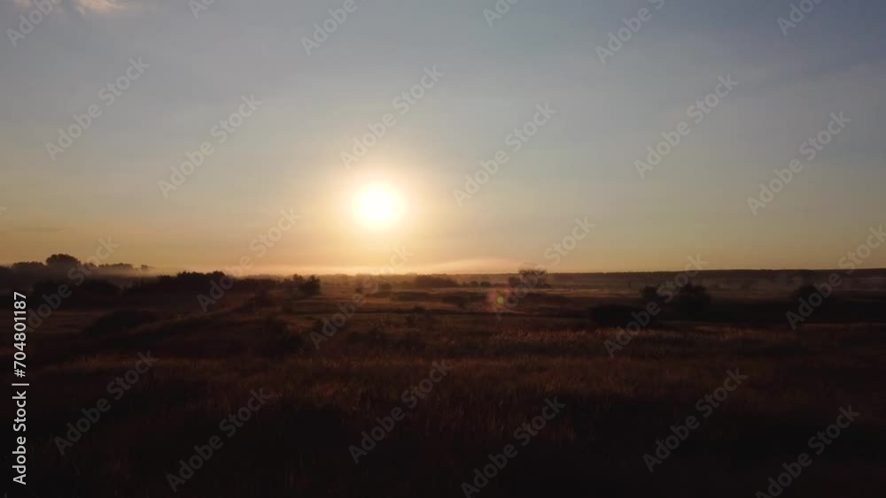 flying at dawn over a field