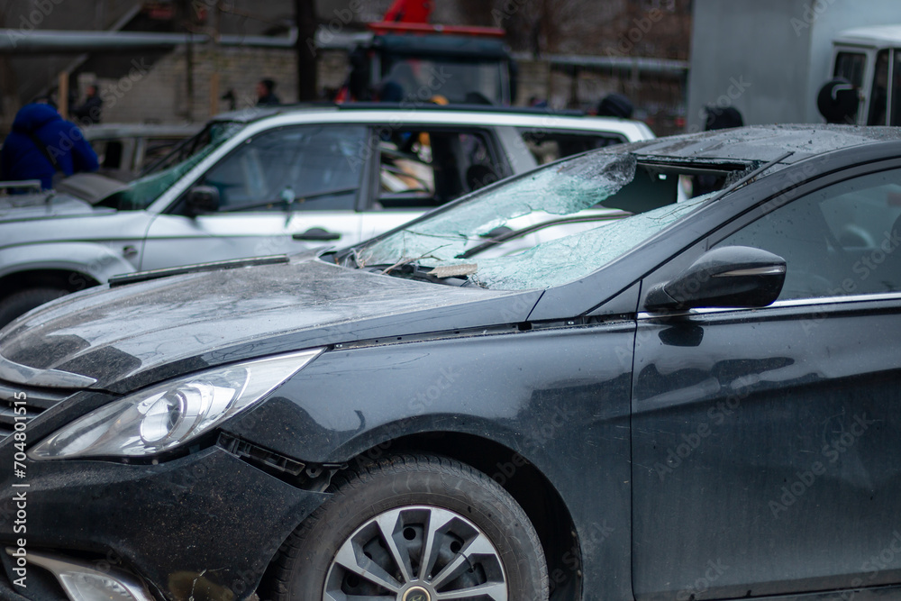 Dnepr, Ukraine – January 6: Russian drones attacked the Dnieper. Burnt and damaged cars in the Dnieper. Utility services clean up the aftermath of the attack on the city.