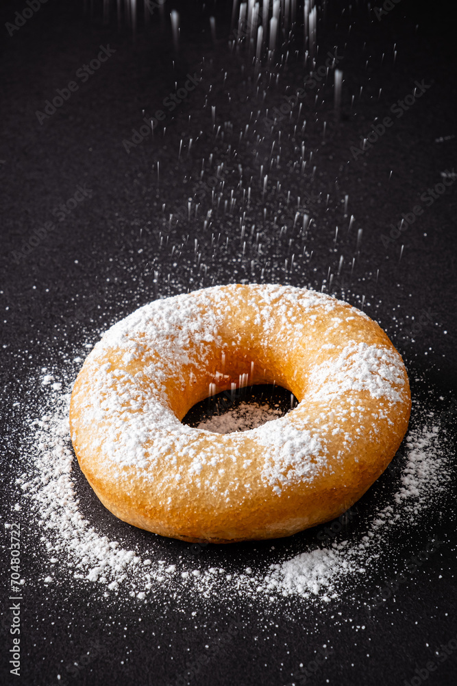 donut with sugar on the black background donut with sugar on the black background