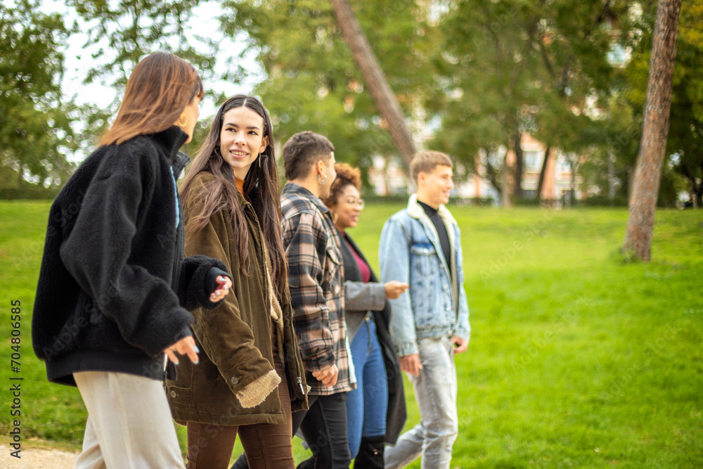 Beautiful, happy girl walks with friends in fall park Beautiful, happy girl walks with friends in fall park