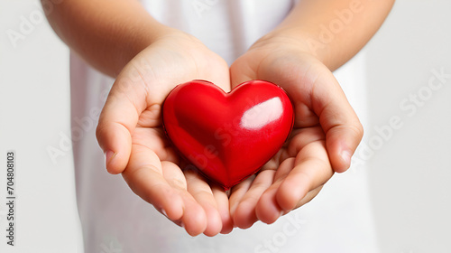 Children s hands holding a heart  a symbol of love and care  ideal for social campaigns and charity.