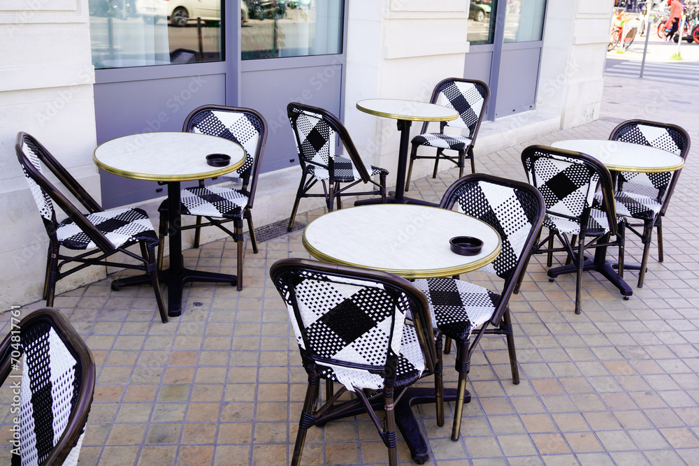 empty tables and chairs paris style in the outdoor bar terrace parisian restaurant