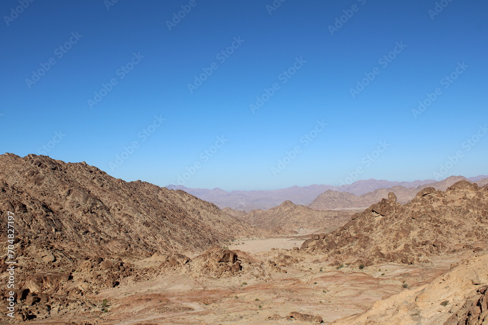 A beautiful  daytime view of the mountain range adjacent to Split Rock in Tabuk, Saudi Arabia.