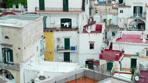 Compact Italian housing and apartments with balconies, shutters and laundry lines on the Amalfi Coast of Italy. photo