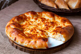 Megrelian khachapuri, round Georgian bread with cheese on a dish, gastronomic tourism and travel to popular places, idea for advertising or menu