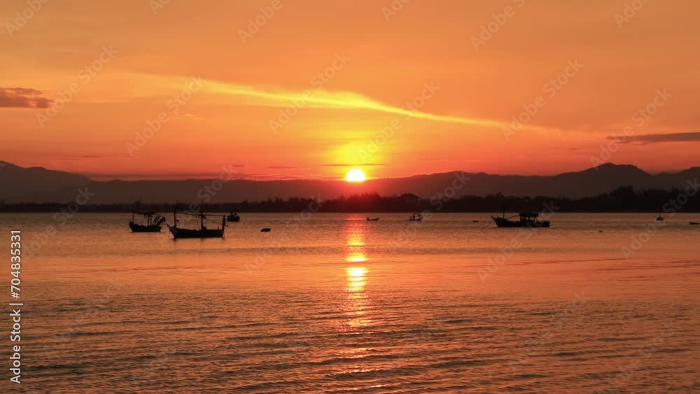 Landscape view evening silhouette Sunset on the ocean with fishing boats and mountain in the background Landscape view evening silhouette Sunset on the ocean with fishing boats and mountain in the background
