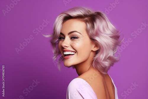 portrait of beautiful woman smiling and showing teeth on colour background 