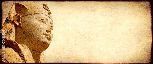 Grunge background with paper texture and face of sphinx statue. Horizontal banner with ancient egyptian sphinx in Alexandria. Copy space for text. Mock up templat