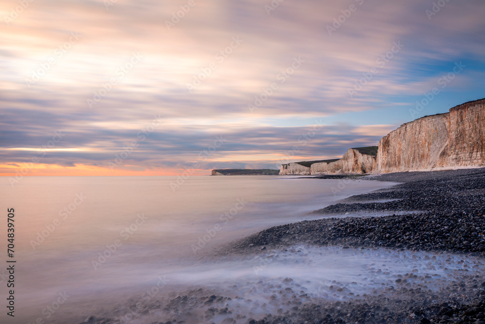 Obraz premium January sunset high tide at Birling gap and the seven sisters cliffs on the east Sussex coast south east England UK
