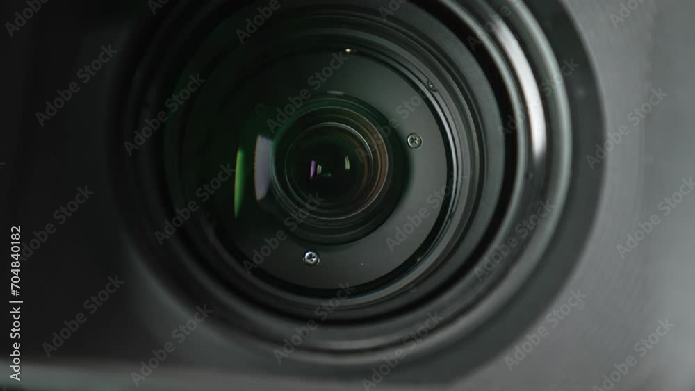 Macro video of the working lens of a camcorder with inner rings and lenses inside. Close-up shooting zooming with the lens of a professional video camera while shooting in the studio.