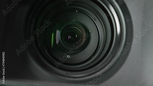 Macro video of the working lens of a camcorder with inner rings and lenses inside. Close-up shooting zooming with the lens of a professional video camera while shooting in the studio. photo