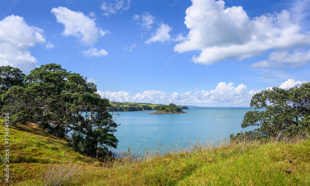 Views of the Hauraki Gulf under a blue sky with white clouds. Waiheke Island. New Zealand.