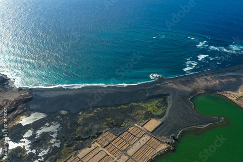 On the south coast of Lanzarote, near the fishing village of El Golfo, is the salt mining plant Salinas de Janubio, which is separated from the open sea by a headland. Aerial view. Canary Islands. photo