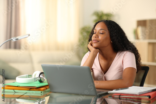 Black student relaxing at home