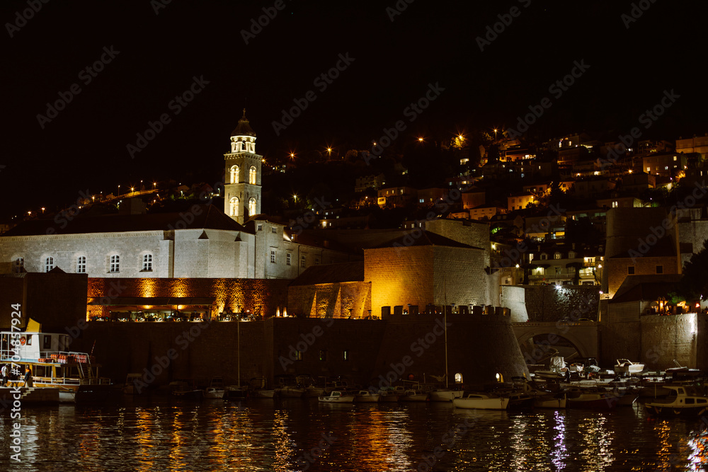 Amazing view of Dubrovnik old city and the boats in a marina in the evening. Travel destination in Croatia. Amazing view of Dubrovnik old city and the boats in a marina in the evening. Travel destination in Croatia.