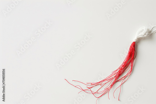 A minimalist yet elegant photograph of a Martisor symbol, meticulously on a white backdrop