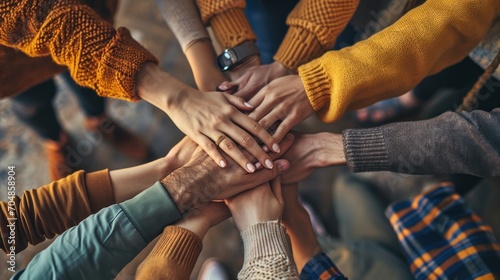  a group of people putting their hands together in the middle of a circle with their hands on top of each other. photo