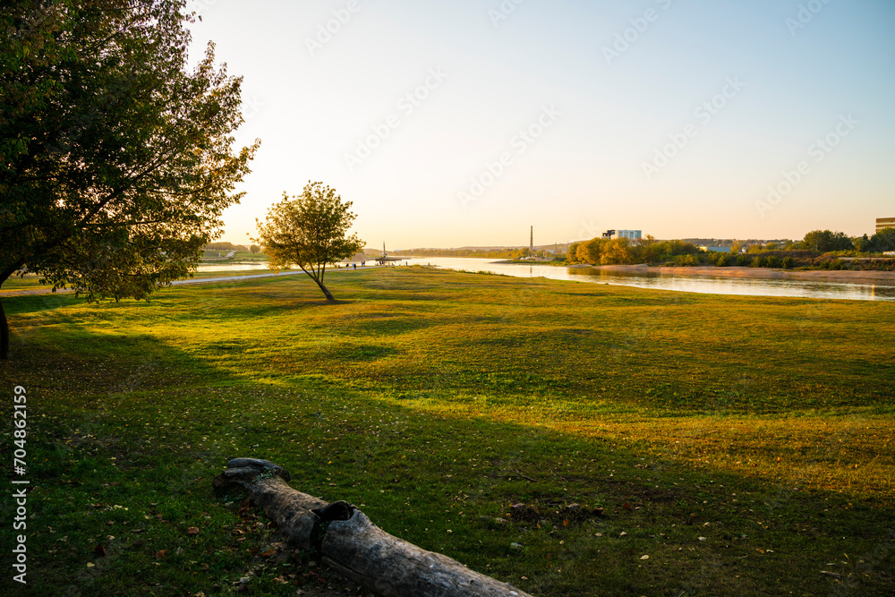 Lithuania, Stream bifurcation nature landscape of neris and neman river water in santakos park in kaunas city at sunset in warm sunset light
