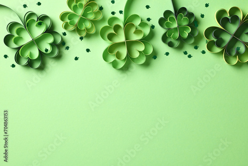 Frame top border made of four leaf clover paper cut and confetti on green background. Saint Patricks Day banner design
