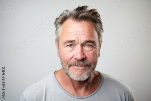 Handsome middle age man with grey hair and beard. Studio shot.