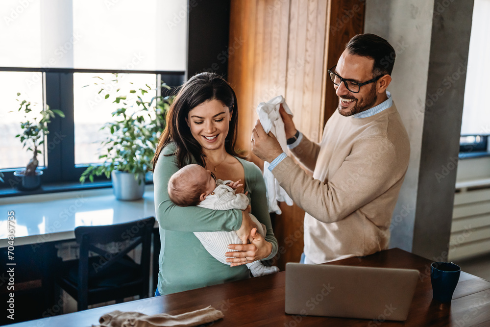 Family, adoption, baby, parenthood and people concept. Happy mother father with newborn baby at home Family, adoption, baby, parenthood and people concept. Happy mother father with newborn baby at home