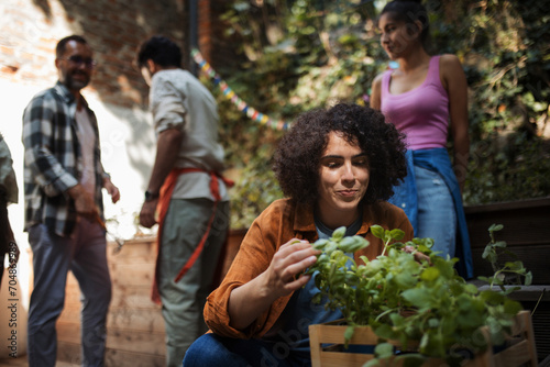 Volunteers at neighbourhood project planting herbs in community garden