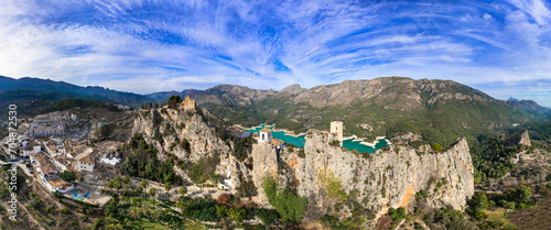 Fototapeta Naklejka Na Ścianę i Meble -  Landmarks of Spain. medieval village Guadalest, aerial drone view scenery with castle on the rocks and turquoise lake. Alicante province