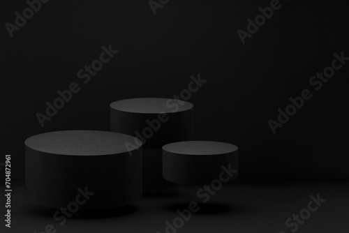 Three black round soaring podiums, set, mockup on black background, shadow. Template for presentation cosmetic products, gifts, goods, advertising, design, display, showing in exquisite style.
