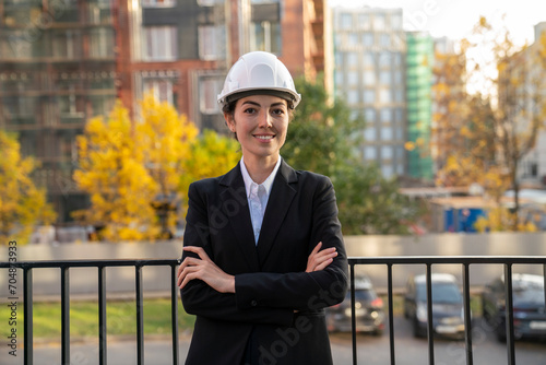 Smiling engineer standing in front of railing in city photo