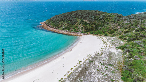 drone view of an Australian beach that joins an island and separates the sea in two