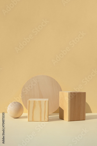 Wooden scenes of different geometric shapes on a beige background. Premium podium for advertising your product. Showcase, display case. Minimal backdrop for product presentation.