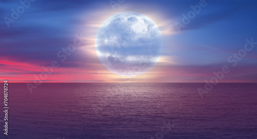 Full moon over the sea at sunset  Elements of this image furnished by NASA 