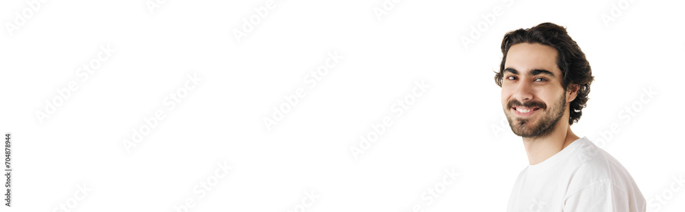 Banner. Young man with dark thick curly hair looking at camera against white studio background with negative space to insert text. Concept of natural beauty, youth, spa treatment, selfcare, cosmetic. Banner. Young man with dark thick curly hair looking at camera against white studio background with negative space to insert text. Concept of natural beauty, youth, spa treatment, selfcare, cosmetic.