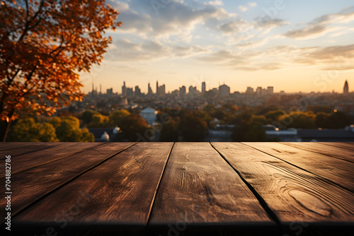 The empty wooden table top showcases the city park skyline