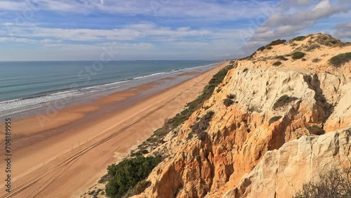 Arenosillo beach, located in Huelva, Spain. Explore the serene beauty of this coastal paradise with its sunlit sandy shores and the rhythmic ebb and flow of the Atlantic Ocean. photo