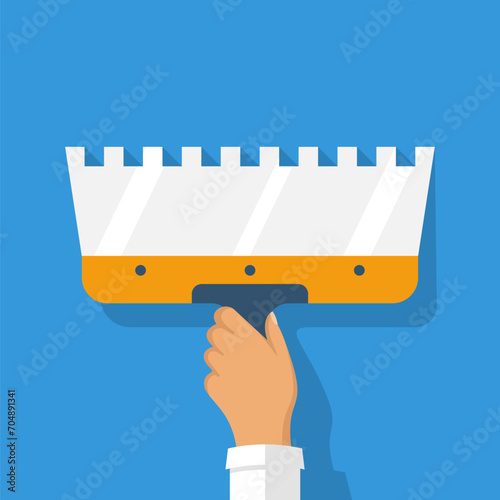 The builder holds a construction spatula in hand. Putty knife in the hand of a home master. Cement trowel. Construction and repair. Apply plaster or putty. Vector illustration flat design.