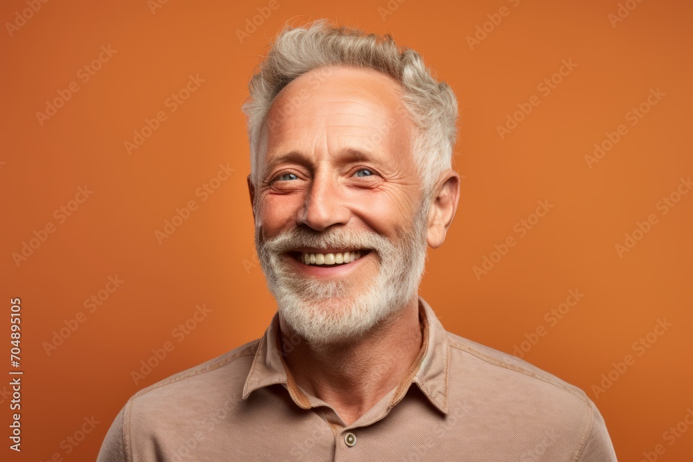 Portrait of a smiling senior man. Studio shot over orange background. Portrait of a smiling senior man. Studio shot over orange background.
