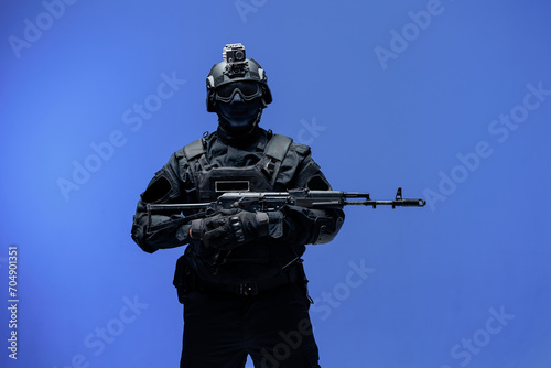 Soldier in black uniforms with weapon gun in studio. Banner Military army concept