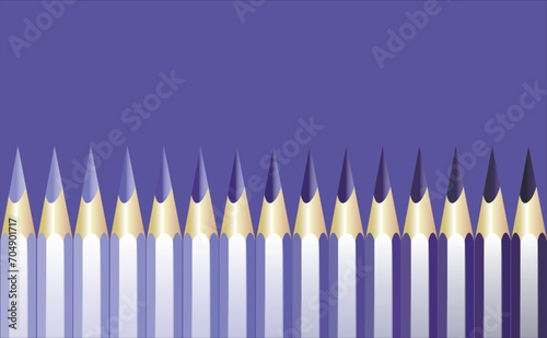 Realistic pencils sharpened in shades of blue and purple lined up against a purple background in color. Close-up. copy space.