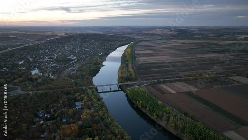 flight in the evening over the river parallel to the Dniester River bridge photo