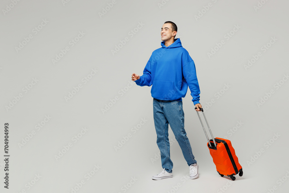 Traveler young middle eastern man wear blue casual clothes hold bag go isolated on plain solid white background. Tourist travel abroad in free spare time rest getaway. Air flight trip journey concept.