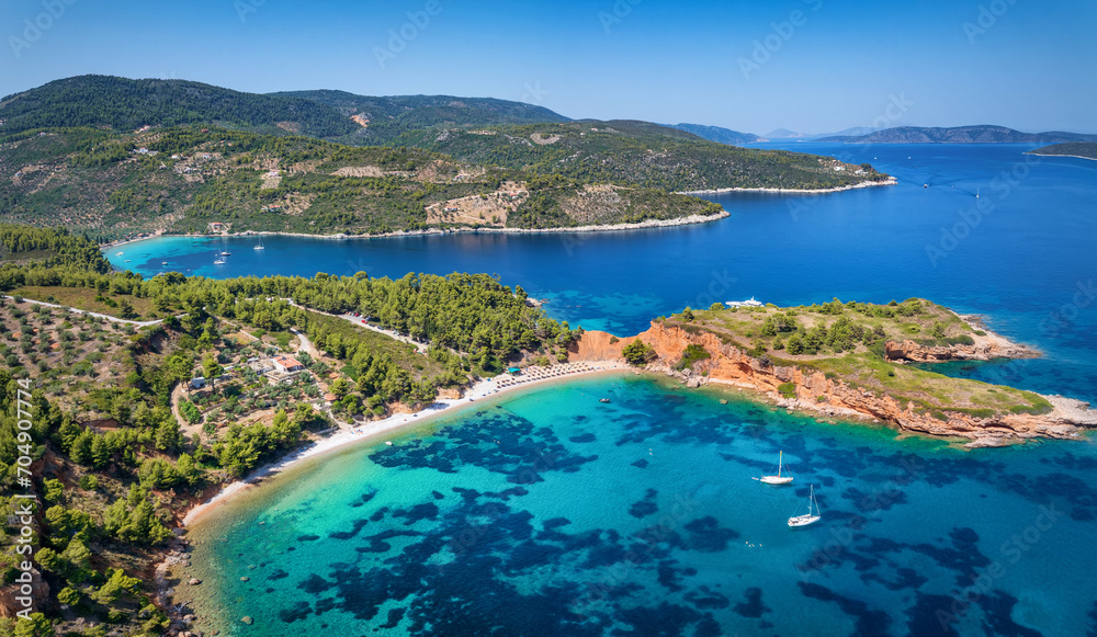 Aerial view of the impressive Kokkinokastro Beach at Alonissos island, Sporades, Greece, with red cliffs leading into the turquoise sea
