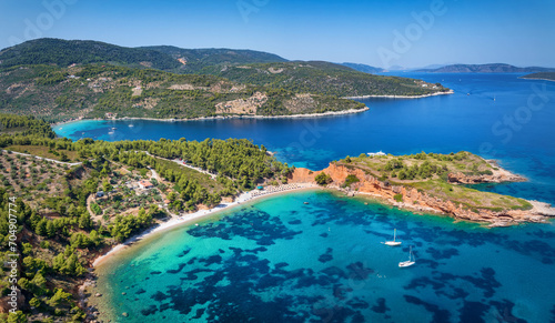 Aerial view of the impressive Kokkinokastro Beach at Alonissos island, Sporades, Greece, with red cliffs leading into the turquoise sea © moofushi