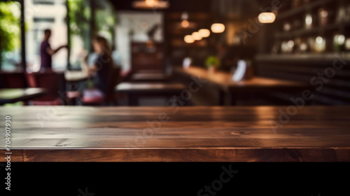 Empty wooden table and coffee shop blur background with bokeh image.