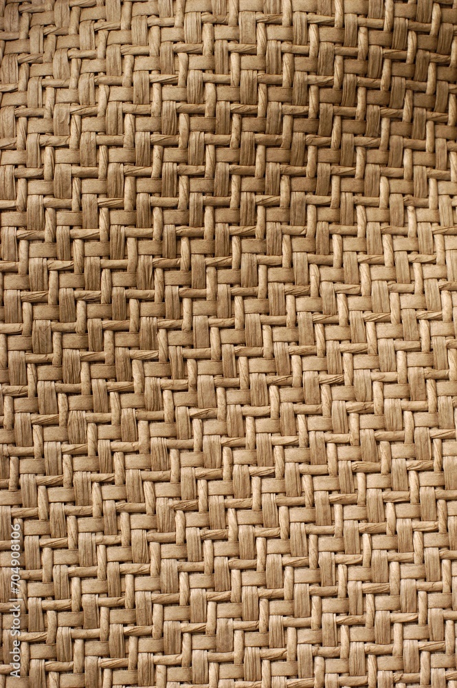 Vertical of a brown woven wavy fabric background Vertical of a brown woven wavy fabric background
