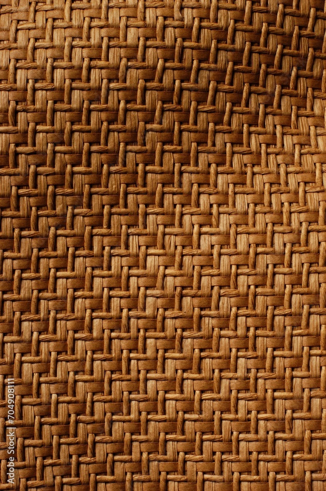 Vertical of a brown woven wavy fabric background Vertical of a brown woven wavy fabric background