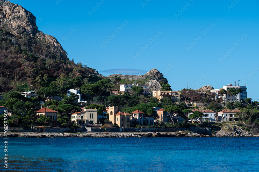 Holiday houses on the green mountain slope at the coast, Isola delle Femmine, Sicily