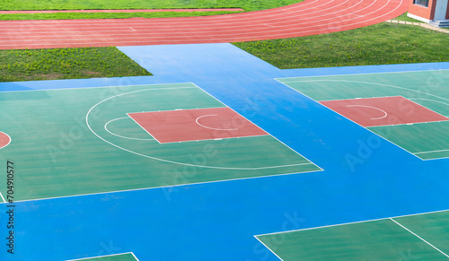 School sport field with basketball court and track photo